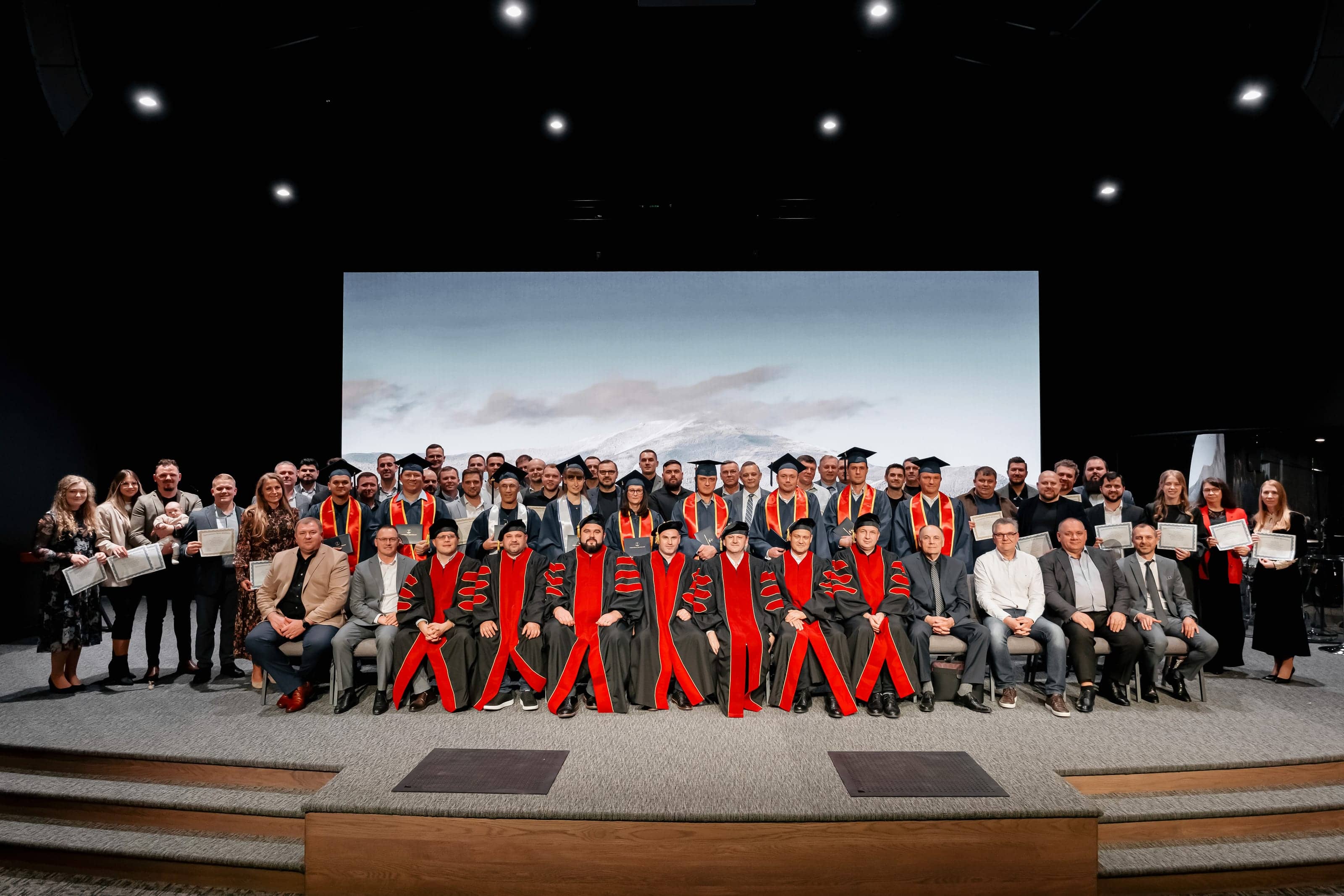 IBS graduation ceremony — graduates and faculty on stage